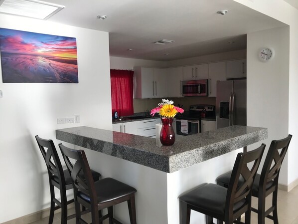 Full kitchen and bar seating. All the comforts of home!