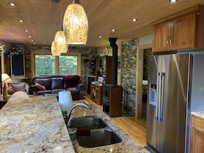 View from kitchen into the living room.  New stainless refrigerator. 