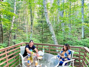 Enjoy eating and drinking on the back deck under a canopy of trees!