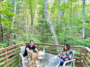 Enjoy eating and drinking on the back deck under a canopy of trees! 