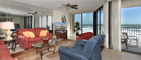 Beautifully decorated, oceanfront living room with recliner and queen sofa sleeper.