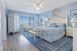 Ocean view master bedroom with king-sized bed, with access to the wrap-around balcony and private bath.