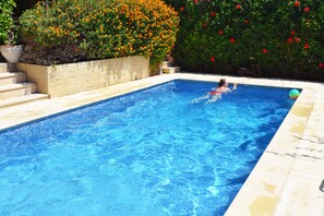 Pool surrounded by mature garden providing privacy and seclusion