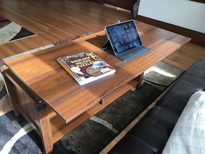 Our furnishings are made for travelers; this coffee table becomes a desk!