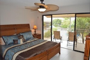 Master Bedroom with views of the sunsets, pool and saltwater lake.