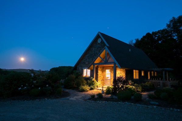 Main entrance of the cottage with the rising moon coming up over the river.