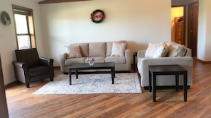 living room open to kitchen and dining with stunning wide plank wood floors