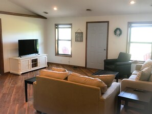 living room with queen sofa sleeper and 50in smart TV.