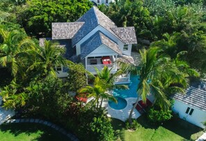 Relax in an oasis of mature trees, bougainvillea, oleander and night jasmine