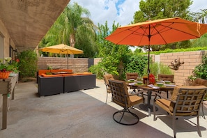 Large private courtyard with separate dining & lounge areas, each with umbrella