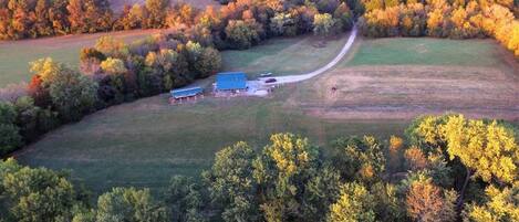 Drone over river looking back at the farm.