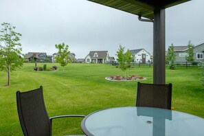 Back porch has outdoor seating and a propane grill