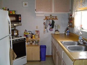 Fully furnished kitchen with oven, microwave, coffee maker, rice maker, blender