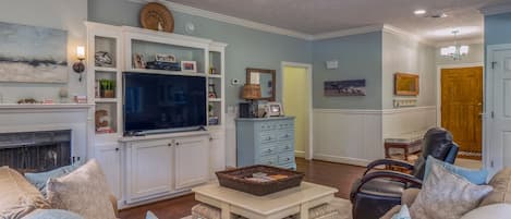Hardwood floors, wainscot, built in bookshelves and a large HDTV  are just some of the updated features throughout (fireplace is decorative only).