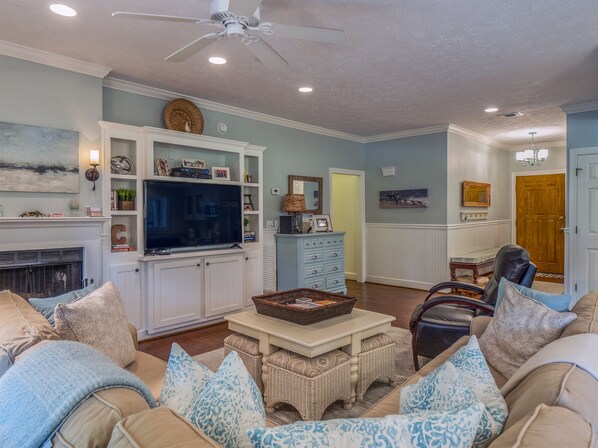 Hardwood floors, wainscot, built in bookshelves and a large HDTV  are just some of the updated features throughout (fireplace is decorative only).