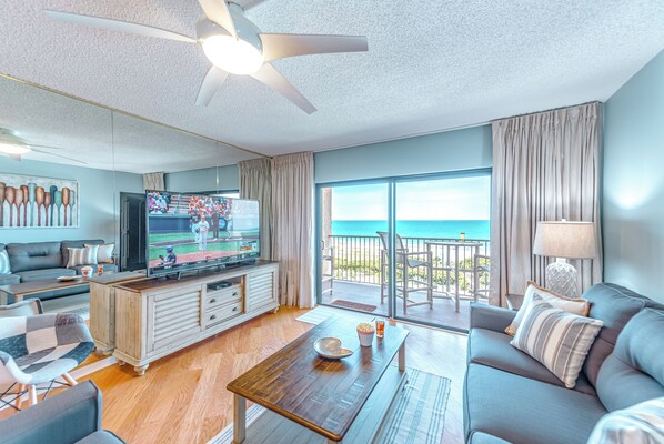 Relax in the stylish living room with ocean views and a 65” HD TV.