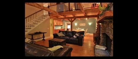 Great room with 24ft ceilings looking into back family and kitchen