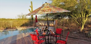 Pool side shade and natural desert landscaping.