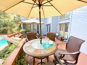 Plenty of outdoor dining options on our poolside  back deck