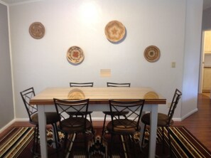 Dinning room with high top table that seats six.
