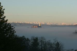 The castle of Montegrosso d'Asti viewed from the house in the morning mist