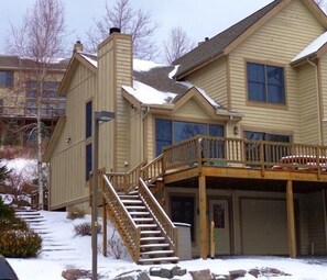 Front of house with large deck facing slopes