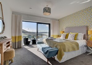 The spacious master king size bedroom has been stylishly decorated in yellows and greys