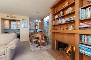 View the kitchen from the living room with a gas fireplace. 