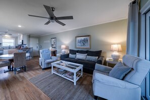 The living room is open to the dining and kitchen areas.