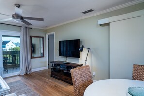 Sliding doors lead to a screened porch with great marsh views. Watch shows and movies on the large wall mounted smart HDTV.