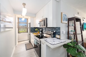 Cook your favorite meals in your fully equipped kitchen plus a glimpse of the Diamond Head Mountain!