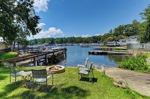 Firepit overlooking lake and cement ramp for entering the lake. Boat docking too