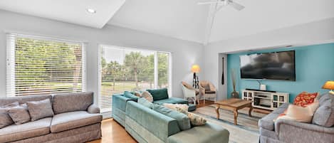 Enjoy the open living area. This bright home has hardwood floors and an inviting blue and white decor.