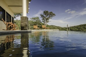 View of pool, patio and sun deck from covered bar