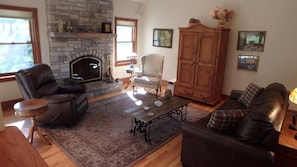 Living room with beautiful cut stone fireplace.