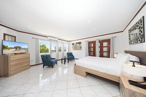 Experience unparalleled comfort in the phenomenal main bedroom. Sink into the king-size bed, where dreams are indulged amidst plush linens. Wake up to spectacular views through the bedside window, offering a glimpse of Aruba's nature
