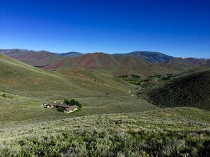 Summer- the house seen from hiking up the backyard- with Baldy views.