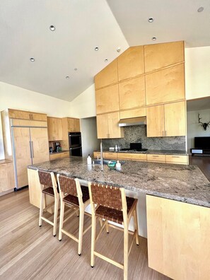 Fully stocked kitchen with bar seating