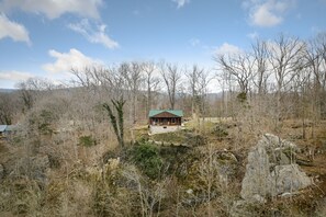 Drone picture of cabin on cliff from the river