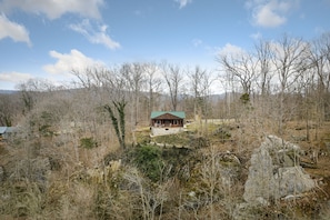 Drone picture of cabin on cliff from the river