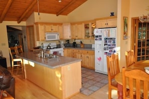 Kitchen with new stainless steel range and microwave.  Fully equipped kitchen