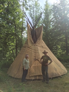 Traditional tipi surrounded by forest