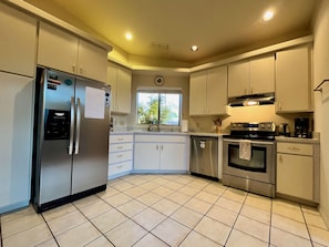 Open kitchen with lots of work space and storage. 