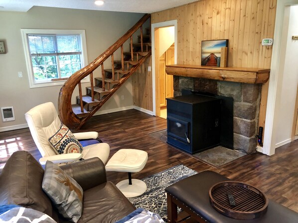 Main house - Living room. Historic staircase railing, and fireplace mantle 