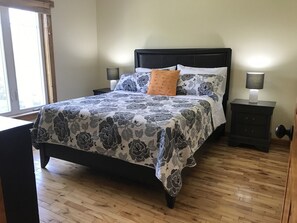Master bedroom with queen size bed and wonderful view of pond and yard.