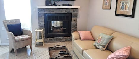 Decorative fireplace,  large screen tv, and queen sleeper sofa. 