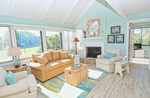 This cottage has new gray toned wood floors, high ceilings & comfy furnishings.