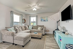 Living room with large comfy sectional and 50in TV. 