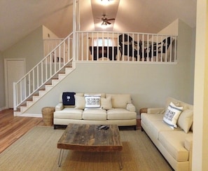 Open concept living area with staircase to the Mahogany pool table loft above