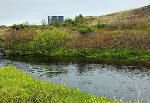 Exterior of the cottage with a river view.